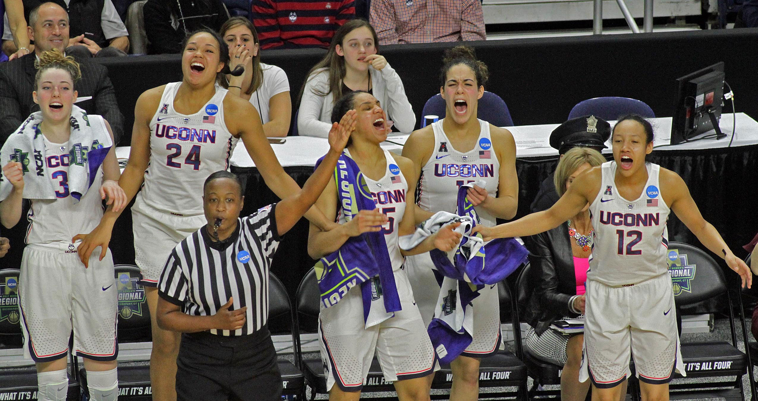 Group shot of UConn Women's Basketball team members cheering. From left:Katie Lou Samuelson '19 (CLAS), Napheesa Collier '19 (CLAS), Gabby Williams '18 (CLAS), Kia Nurse '18 (CLAS), and Saniya Chong '17 (CLAS) cheer on teammates (not pictured) Molly Bent '20 (ACES), Natalie Butler, Crystal Dangerfield '20 (ACES), Kyla Irwin '20 (CLAS), and Tierney Lawlor '17 (CAHNR) during their Elite Eight defeat of Oregon.